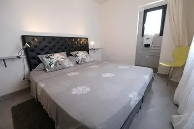 a bedroom with a large bed in a room at charming family house with pool located at L'isle sur la sorgue - sleeps 8 in LʼIsle-sur-la-Sorgue