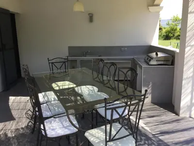 a glass table and chairs in a kitchen at charming family house with pool located at L'isle sur la sorgue - sleeps 8 in LʼIsle-sur-la-Sorgue