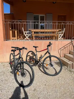 two bikes parked in front of a building at La Maison Bougnette in Flassan