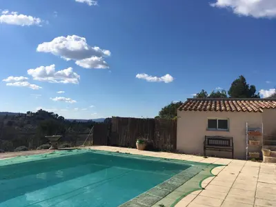 a swimming pool in front of a house at L'Eden in Ansouis