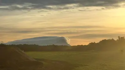 a lenticular cloud over a field at sunset at Villa en campagne avec piscine et jacuzzi in Aix-en-Provence