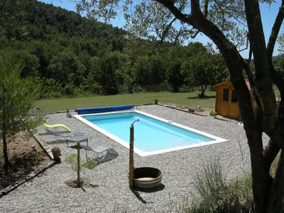 a swimming pool in a yard with a tree at Résidence de gîtes La Sidoine du Mont-Ventoux in Crillon-le-Brave