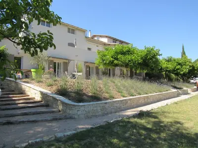 a building with stairs and plants in front of it at Résidence de gîtes La Sidoine du Mont-Ventoux in Crillon-le-Brave