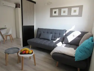a living room with a couch and a table with a bowl of fruit at Résidence de gîtes La Sidoine du Mont-Ventoux in Crillon-le-Brave