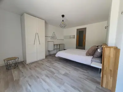 a white bedroom with a bed and a desk at Résidence de gîtes La Sidoine du Mont-Ventoux in Crillon-le-Brave