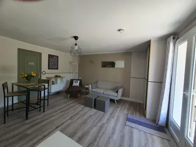 a living room with a table and a couch at Résidence de gîtes La Sidoine du Mont-Ventoux in Crillon-le-Brave