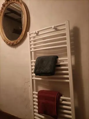 a towel rack in a bathroom with a mirror at Entre Terre et Ciel. in Saignon