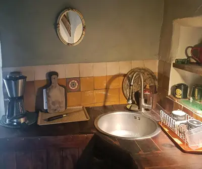 a kitchen counter with a sink and a mixer at Entre Terre et Ciel. in Saignon