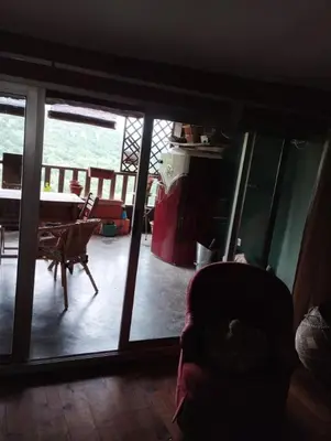 a room with a view of a living room with a table at Entre Terre et Ciel. in Saignon