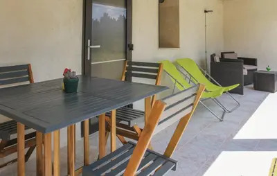 a dining room with a table and chairs at Maison 4 étoiles et Studio 3 étoiles indépendants avec piscine in LʼIsle-sur-la-Sorgue