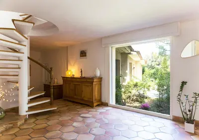 a hallway with a staircase and a large sliding glass door at Au Coeur des Vignes en Provence in Châteauneuf-de-Gadagne