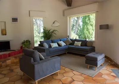 a living room with a blue couch and chairs at Au Coeur des Vignes en Provence in Châteauneuf-de-Gadagne