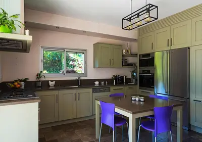a kitchen with a table and purple chairs at Au Coeur des Vignes en Provence in Châteauneuf-de-Gadagne