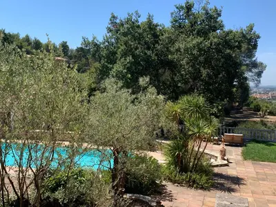 a view of a swimming pool in a garden with trees at La Farigoule - Sainte-Victoire - Vue exceptionnelle sur Aix-en-Provence in Aix-en-Provence