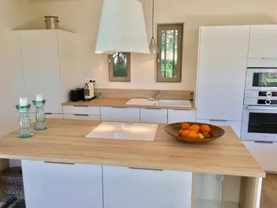 a kitchen with a bowl of fruit on a counter at Le Mas les Pléiades - Private pool - Gordes in Gordes