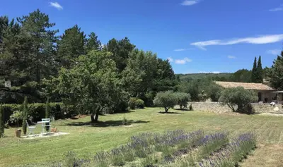 a garden with trees and a house in the background at Le Mas les Pléiades - Private pool - Gordes in Gordes