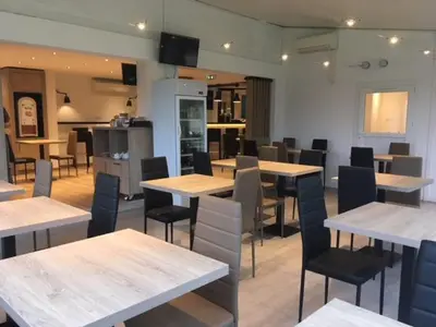 a restaurant with tables and chairs in a room at Brit Hotel Salon de Provence in Salon-de-Provence