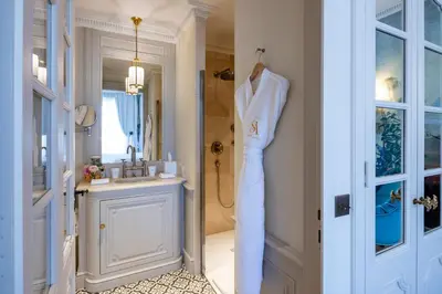 a bathroom with a sink and a robe hanging on a door at Villa Saint-Ange in Aix-en-Provence