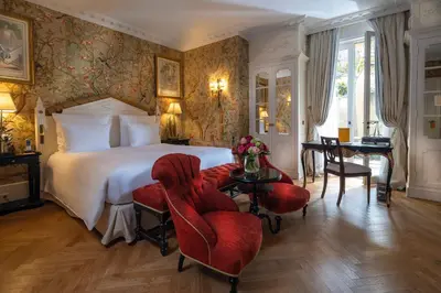 a bedroom with a bed and a table and chairs at Villa Saint-Ange in Aix-en-Provence
