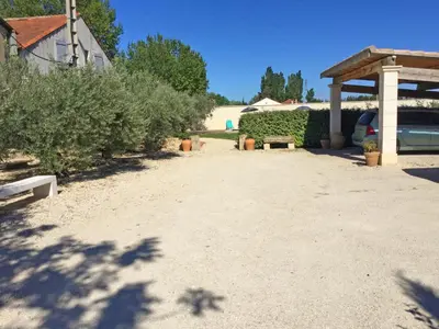 a gravel driveway with a pavilion and some bushes at Large family home with private pool in Vignères, 10 sleeps. in Cavaillon