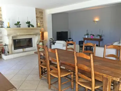 a living room with a wooden table and a fireplace at Large family home with private pool in Vignères, 10 sleeps. in Cavaillon