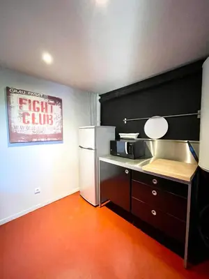 a kitchen with a white refrigerator and a microwave at Loft 52 in Aix-en-Provence