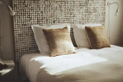 a bed with white sheets and pillows in a bedroom at Domaine de Carraire in Aix-en-Provence
