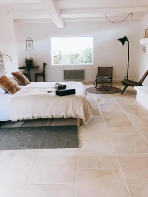 a bedroom with a large bed and a large window at Domaine de Carraire in Aix-en-Provence