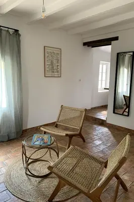 a living room with two chairs and a table at Domaine de Carraire in Aix-en-Provence