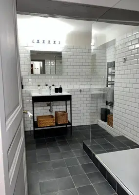 a bathroom with a sink and a white brick wall at Maison Alberta in Aix-en-Provence