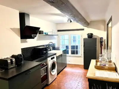 a kitchen with a refrigerator and a washing machine at Maison Alberta in Aix-en-Provence