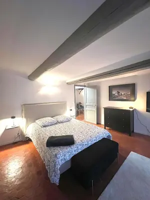 a bedroom with a bed with a white bedspread at Maison Alberta in Aix-en-Provence