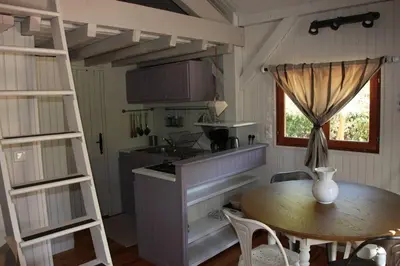 a kitchen with a table and a table and a window at Il Sole in Le Puy-Sainte-Réparade