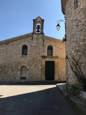 a brick building with a door and a bell tower at Il Sole in Le Puy-Sainte-Réparade