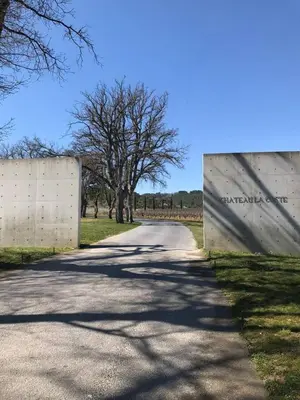 a road with a fence and trees on the side at Il Sole in Le Puy-Sainte-Réparade