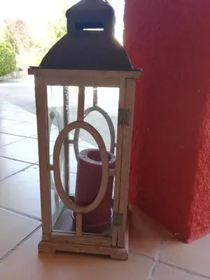 a lantern with a cup in it next to a wall at Le mas de la diligence in Mirabeau