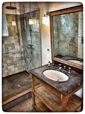 a bathroom with a sink and a shower with a mirror at La Providence in Apt