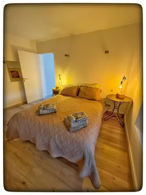 a bedroom with a large bed with two baskets on it at La Providence in Apt