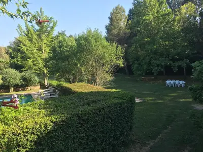 a garden with tables and chairs in the grass at La Jacquemarie in Monteux