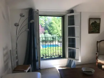 a room with a window with a view of a pool at La Jacquemarie in Monteux