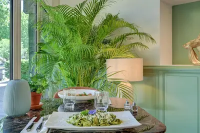 a dining room table with a plate of food on it at Urban Style Hotel Blason du Ventoux in Carpentras