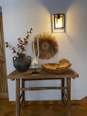 a table with a vase and a basket on it at le jas de Saint Hilaire in Ménerbes