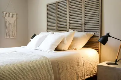a bedroom with a large bed with white pillows at le jas de Saint Hilaire in Ménerbes