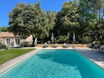a swimming pool in front of a house at le jas de Saint Hilaire in Ménerbes