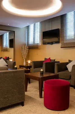a living room with couches and a flat screen tv at Escale Oceania Aix-en-Provence in Aix-en-Provence