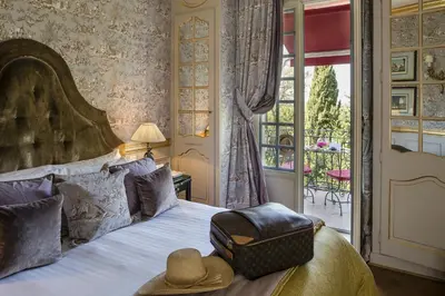 a bedroom with a bed with a hat on it at Villa Gallici Hôtel & Spa in Aix-en-Provence