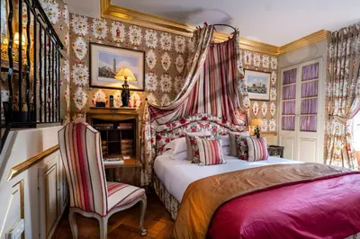 a bedroom with a bed and a table and a chair at Villa Gallici Hôtel & Spa in Aix-en-Provence