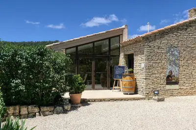 a brick building with a sign in front of it at Le Hameau Fleur de Pierres , Chambre , Gite et Table d'Hôtes in Murs