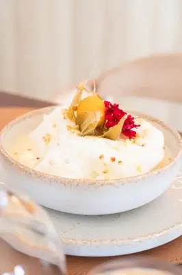 a bowl of food on a plate on a table at Golden Tulip Avignon Le Paradou in Avignon