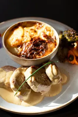 a plate of food with a bowl of food on it at Golden Tulip Avignon Le Paradou in Avignon